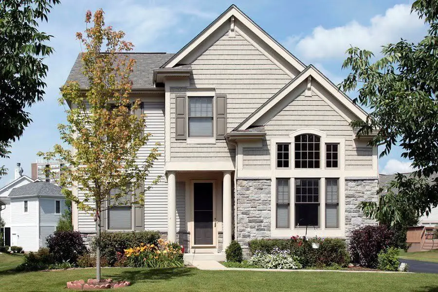 home-with-tan-siding-and-column-entry